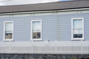 Three windows on timer weatherboard wall
